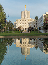 Photo of the Oregon State Capitol building reflecting in a large pool.